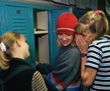 Girls whispering at locker