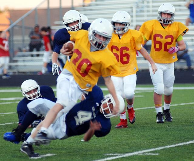 7th grade football running back getting tackled