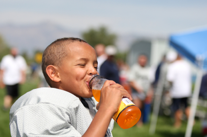 African-American youth football player with sports drink