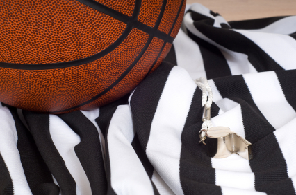 Basketball, referee's jersey, and whistle