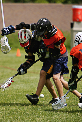 Lacrosse players colliding going for loose ball
