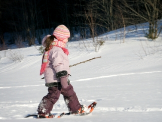 Young girl snowshoeing