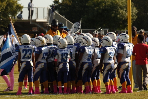 Youth football players with coach