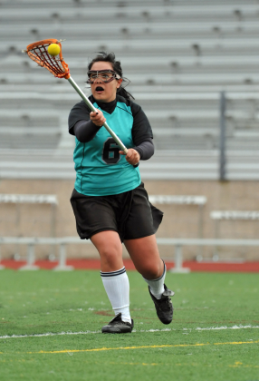 Girl lacrosse player receiving pass