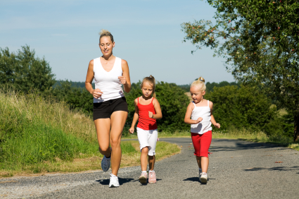 Mom jogging with her two young daughters