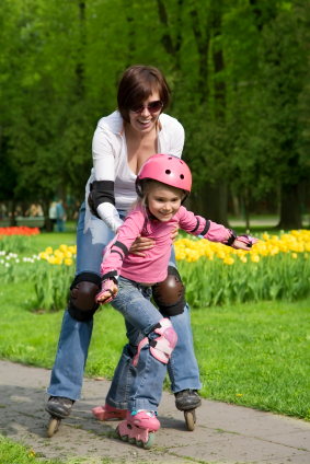 Mom helping daughter to roller blade