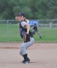 Youth baseball pitcher delivering to the plate