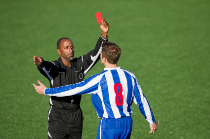 Soccer referee showing player red card