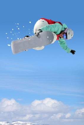 Snowboarder grabbing board