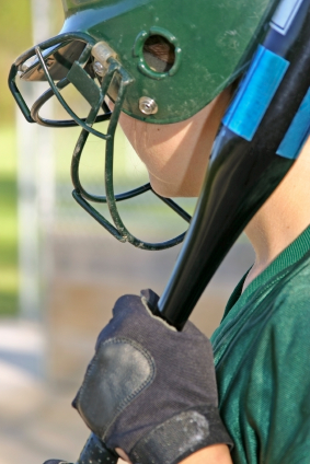 Female softball batter with helmet and bat
