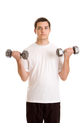 Teenage boy with hand held weights