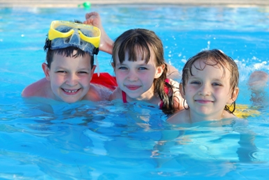 Three kids in a swimming pool