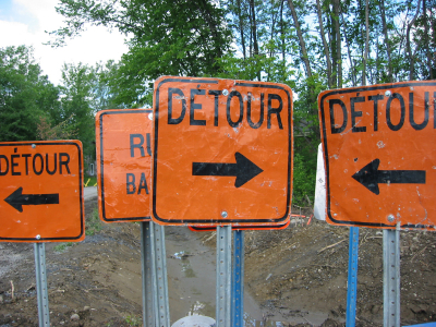 Detour signs pointing in different directions