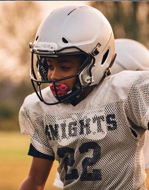Youth football player wearing Vicis helmet