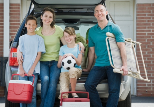 Sports family in front of minivan