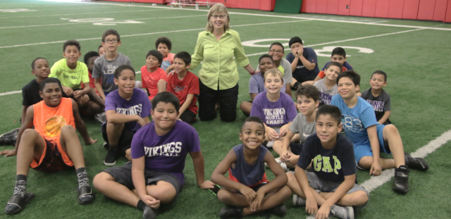 Brooke de Lench with Grand Prairie Texas youth football players