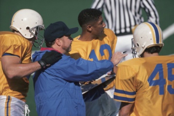 Football coach talking with players