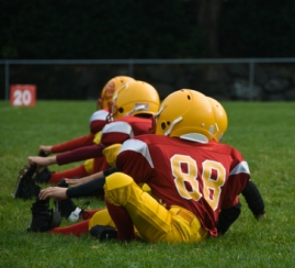 Youth football players stretching