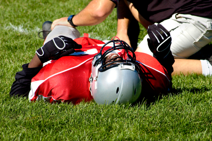 Football player with possible concussion