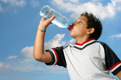 Young boy drinking from water bottle