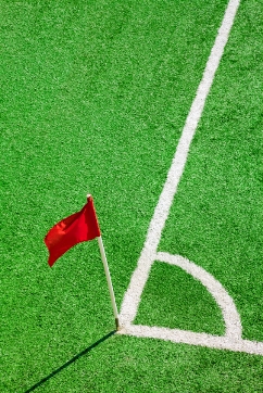 Red corner flag on artificial turf field