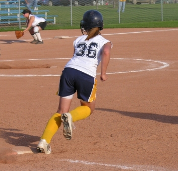 Softball player running bases