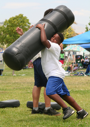Football players with tackling dummy